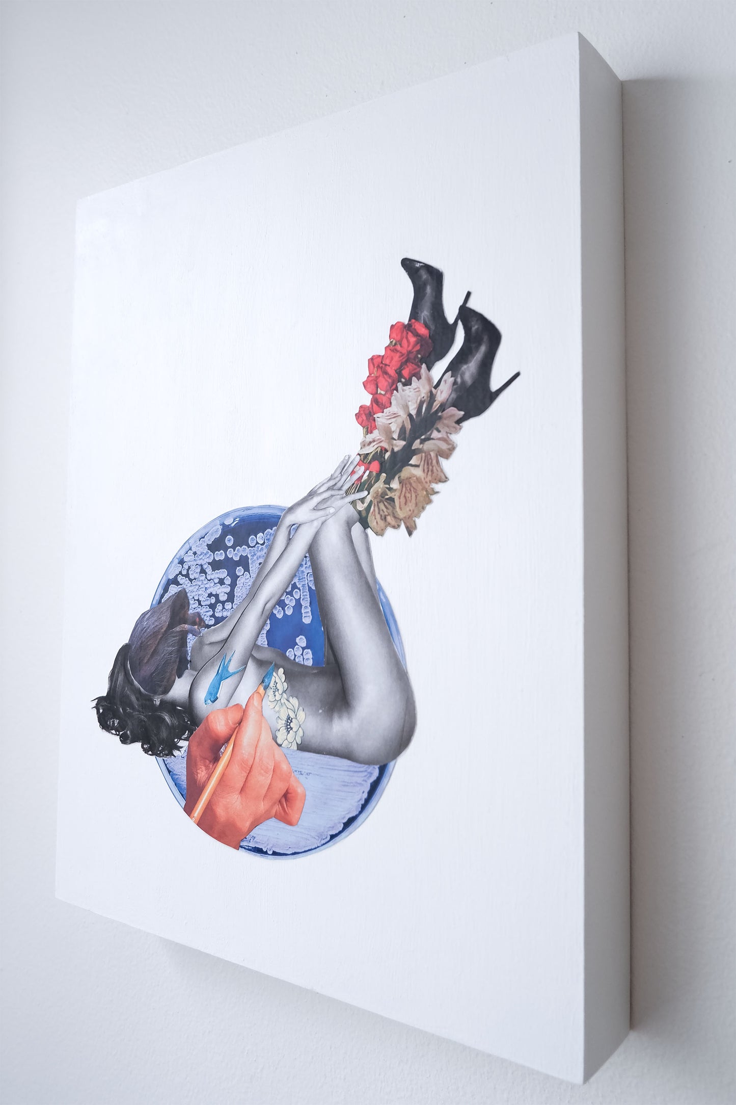 side view of Botanical Ink collage shows depth of wood board that is the white painted collage background