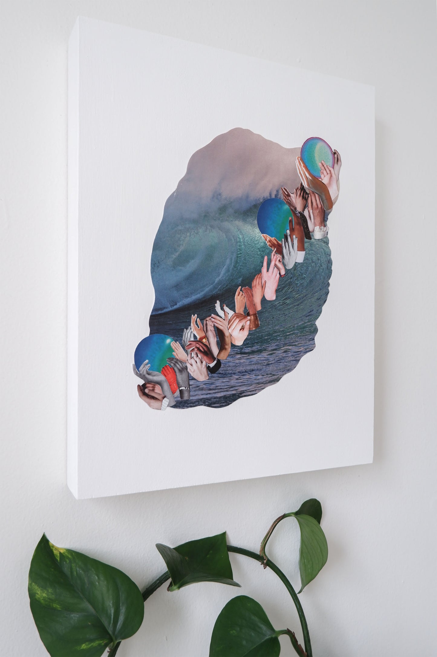 Angled view of Three Waves collage mounted on white painted wood Canadian made birch panel