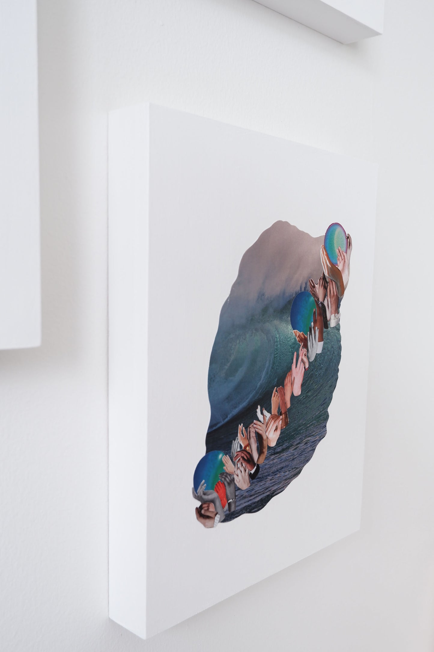 side view of Three Waves collage shows depth of wood board that is the white painted collage background