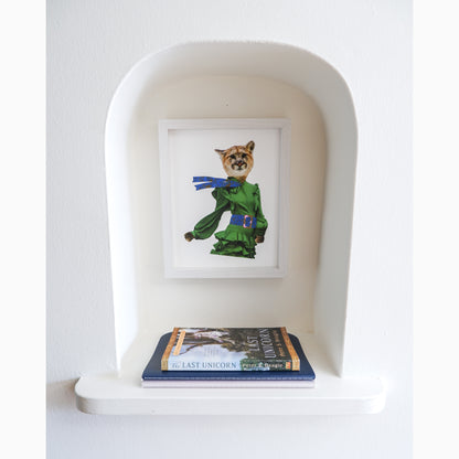 fine art print of confident kat, an 8 by 10 inch print in a white frame in a nook with two books sitting below