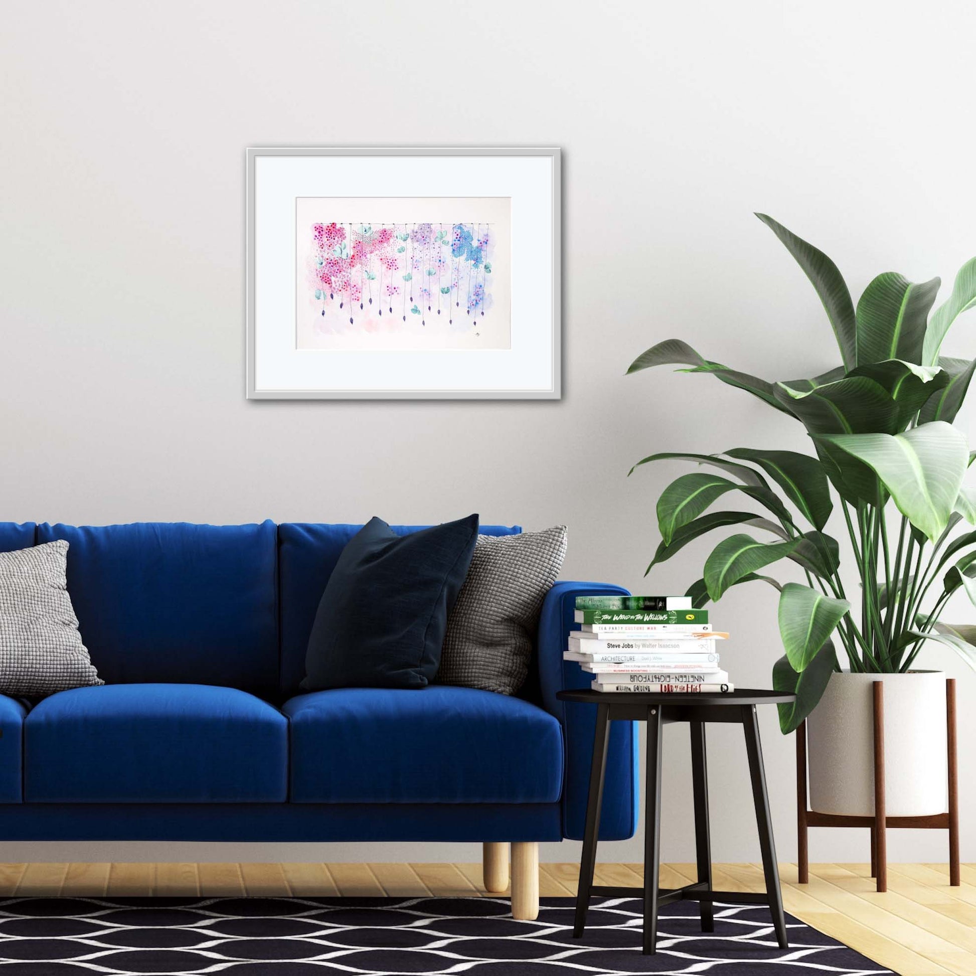 framed delicate dangle painting in living room with blue velvet couch
